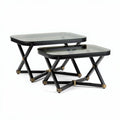 Glass top nesting tables set with black metal base and gold accents